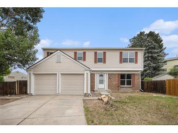 Charming two-story home with a two-car garage, neutral siding, and well-maintained landscaping at 16835 E Harvard Pl, Aurora, CO 80013