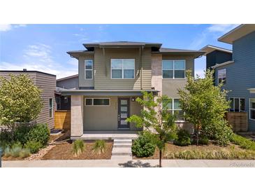 Modern two-story home with a well-manicured front yard and stylish architectural details at 5988 N Boston St, Denver, CO 80238