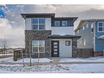 Two-story modern home with stone and siding exterior, welcoming front porch, and attached garage at 960 Superior Dr, Superior, CO 80027