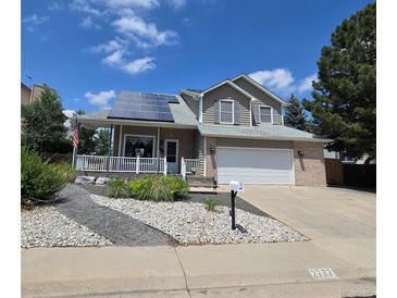 Charming two-story home features a front porch, solar panels, two-car garage, and well-maintained landscaping at 2777 W 106Th Cir, Denver, CO 80234