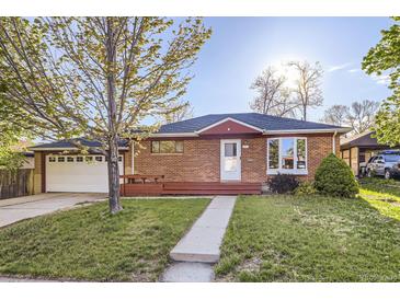Charming brick home featuring a well-maintained front yard and an inviting front porch at 7875 Cyd Dr, Denver, CO 80221