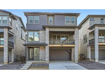 Charming two-story home featuring a stone facade, attached garage, and a small balcony at 3157 S Russell St, Morrison, CO 80465