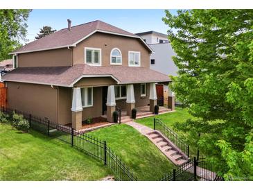 Stunning two-story home with a manicured front yard and inviting porch at 1366 S Vine St, Denver, CO 80210