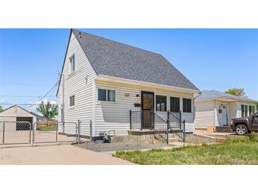 Charming house with white siding, a gray roof, and a well-maintained front yard, perfect for comfortable living at 235 S 8Th Ave, Brighton, CO 80601