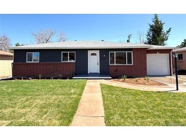 Charming single story home with a manicured lawn, inviting entryway, and beautiful exterior paint scheme at 2274 S Newton St, Denver, CO 80219