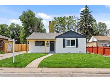 Charming single-story home features a well-manicured lawn and inviting walkway at 851 S Eliot St, Denver, CO 80219