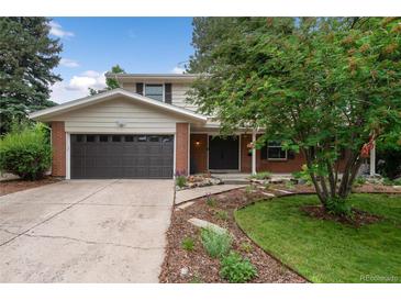 Charming two-story home with landscaped yard and a two-car garage on a sunny day at 8666 E Easter Ave, Centennial, CO 80112