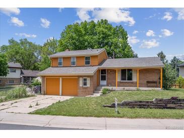 Charming two-story home features a brick facade, two-car garage, and a well-maintained front yard at 3625 E 128Th Pl, Thornton, CO 80241