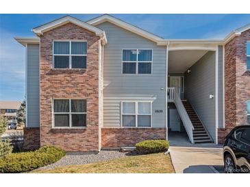 Inviting multi-level condo featuring a mix of brick and siding and a charming entrance staircase at 11620 W 62Nd Pl # 201, Arvada, CO 80004