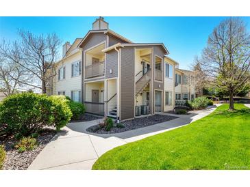 Two-story condo with a private entrance, lovely siding, and well-maintained landscaping at 8705 W Berry Ave # 204, Littleton, CO 80123