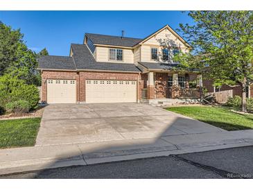 Charming two-story home with a three-car garage, well-kept lawn, and inviting curb appeal at 13018 Niagara Way, Thornton, CO 80602