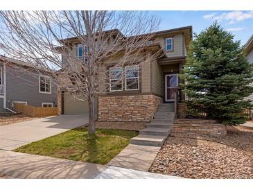 Charming two-story home featuring stone accents, landscaped front yard, and attached two-car garage at 5503 Fullerton Cir, Highlands Ranch, CO 80130