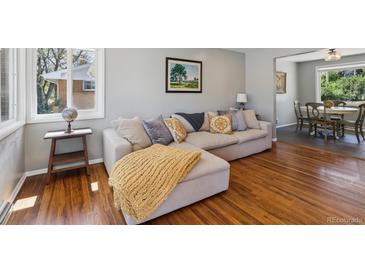 Cozy living room featuring hardwood floors, large sectional couch, and lots of natural light at 269 Beryl Way, Broomfield, CO 80020