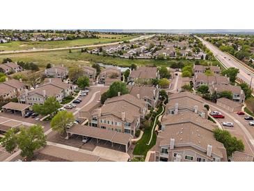 A beautiful aerial view of the condos nestled in a well-kept community with mature trees and landscaping at 3845 Canyon Ranch Rd # 102, Highlands Ranch, CO 80126