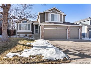 Two-story house with a large yard and attached two-car garage at 5593 S Himalaya Way, Centennial, CO 80015