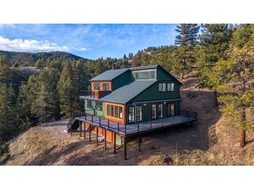 Striking two-story home with multi-level deck and mountain views at 1406 Pika Rd, Boulder, CO 80302