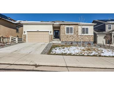 Charming single-story home with a two-car garage and stone accents on the facade at 4689 Coltin Trl, Castle Rock, CO 80104