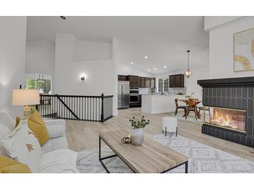 Spacious and open living area showing the kitchen and dining area. Brightly lit and very modern at 1894 S Marshall Cir, Lakewood, CO 80232
