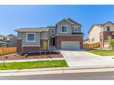 Charming two-story home featuring brick accents, neutral siding, a well-manicured lawn, and a two-car garage at 434 W 128Th Dr, Westminster, CO 80234