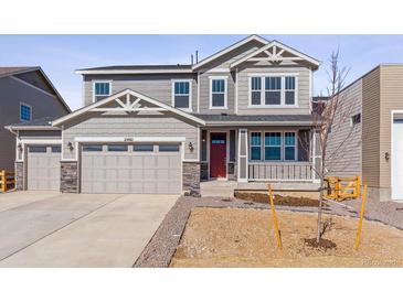 Charming two-story home with a two-car garage and craftsman-style details at 25061 E 38Th Ave, Aurora, CO 80019