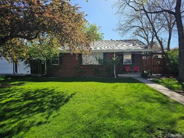 Charming brick home with a well-maintained lawn and mature trees offering shade and curb appeal at 2274 S Cherry St, Denver, CO 80222