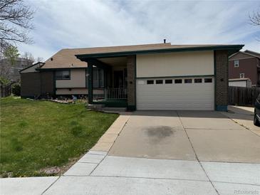 Charming brick and siding home with a well-manicured front yard and attached two-car garage at 4740 W 108Th Pl, Westminster, CO 80031