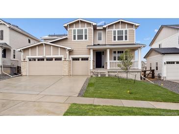 Inviting two-story home featuring a well-manicured lawn and a convenient two-car garage at 5537 Riverbend Ave, Firestone, CO 80504