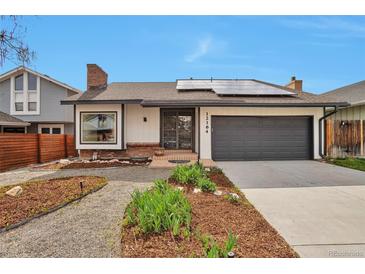 Charming single-Gathering home with a well-manicured front yard, solar panels, and an attached garage at 12164 E Amherst Cir, Aurora, CO 80014
