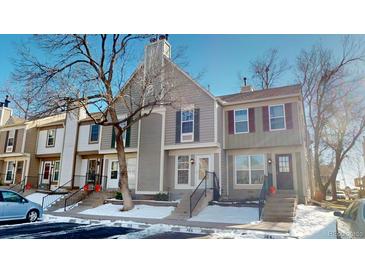 Attractive townhome exterior with snow-covered landscaping at 1811 S Quebec Way # 194, Denver, CO 80231