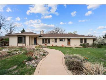 Ranch style home with a charming walkway and well-maintained landscaping at 2020 Routt St, Lakewood, CO 80215