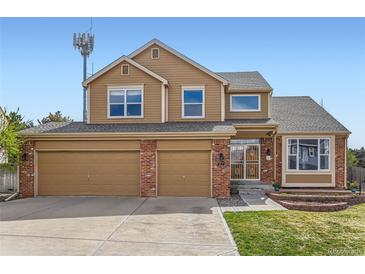 Charming two-story home with a well-manicured lawn and a three-car garage at 884 W 124Th Dr, Denver, CO 80234