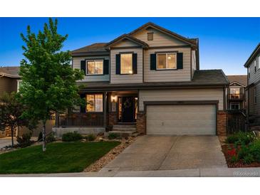 Charming two-story home with a well-manicured lawn and inviting front porch at 13822 Worthington Pl, Parker, CO 80134