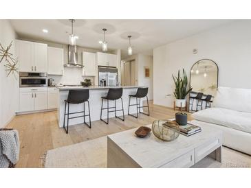 Stylish condo featuring a modern kitchen with stainless steel appliances and an open floor plan at 1735 Central St # 208, Denver, CO 80211