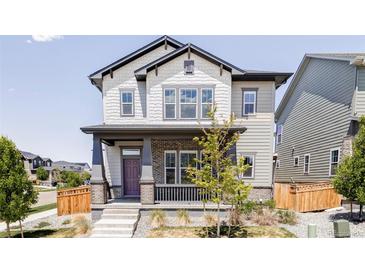 Charming two-story home featuring a covered porch and a beautifully designed exterior at 6037 N Netherland Ct, Aurora, CO 80019