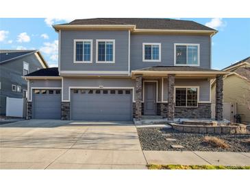 Charming two-story home with a three car garage and a beautifully landscaped front yard at 18824 Robins Dr, Denver, CO 80249