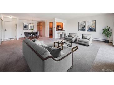 Inviting living room with modern decor and an open floor plan leading to the dining area and kitchen at 13618 E Bethany Pl # 306, Aurora, CO 80014