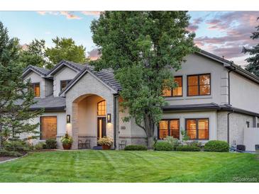 Charming home with a well-manicured lawn, mature tree, and a welcoming brick entryway at 4181 S Ivy Ln, Cherry Hills Village, CO 80111
