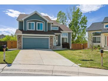 Charming two-story home featuring a two-car garage, well-kept lawn, and classic curb appeal at 12277 Krameria St, Brighton, CO 80602
