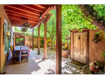 Inviting outdoor patio features a covered dining area and access to a beautifully landscaped garden at 807 9Th St, Golden, CO 80401
