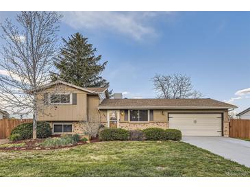 Charming home with a well-maintained front yard, lush lawn, and attached two-car garage at 367 Jupiter Dr, Lone Tree, CO 80124