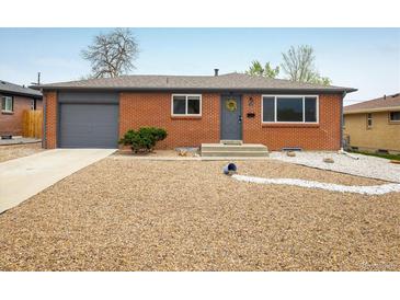 Charming brick ranch-style home with a well-maintained gravel front yard and gray trim at 740 Lotus Way, Broomfield, CO 80020