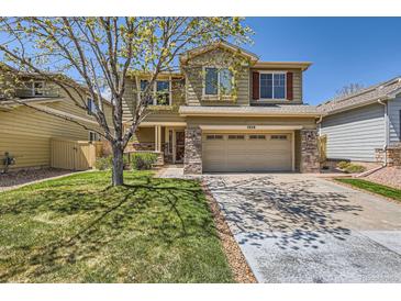 Charming two-story home featuring a two-car garage, stone accents, and a well-maintained front yard at 7838 W Layton Way, Littleton, CO 80123