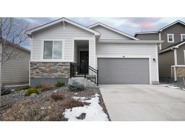 Modern ranch home with gray garage door and stone accents at 20 Vista Canyon Dr, Castle Rock, CO 80104