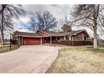 Charming brick single-Gathering home with a well-manicured lawn, a two-car garage, and a welcoming front porch at 3820 S Ames St, Denver, CO 80235