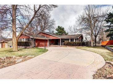 Spacious brick home with an attached garage and beautiful landscaping at 3820 S Ames St, Denver, CO 80235