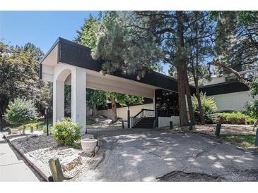 Welcoming entrance to the building with a covered drive-through and meticulously landscaped grounds at 2375 S Linden Ct # 201, Denver, CO 80222