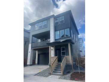 Modern two-story home with a covered porch, neutral paint scheme, and stone accents at 8859 Waterleaf Ln, Littleton, CO 80125