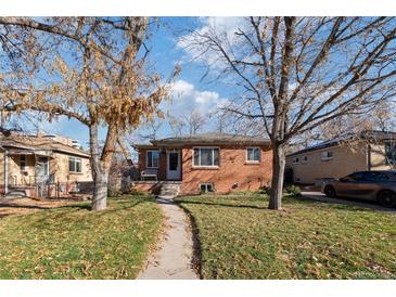 Brick ranch home with landscaped yard and walkway at 2640 S York St, Denver, CO 80210