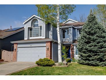 Charming two-story home with a well-maintained lawn, mature trees, and an attached two-car garage at 2937 W Yarrow Cir, Superior, CO 80027
