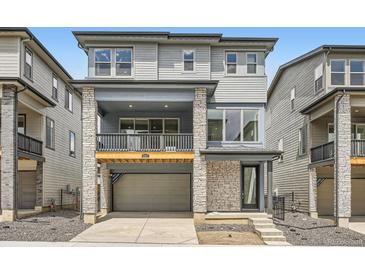 Beautiful three-story home featuring stone accents, a two-car garage, and an inviting covered porch at 3127 S Russell St, Morrison, CO 80465
